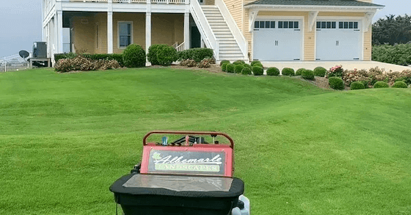 Professional landscaping team working on residential property in North Carolina with various materials and equipment affecting project costs